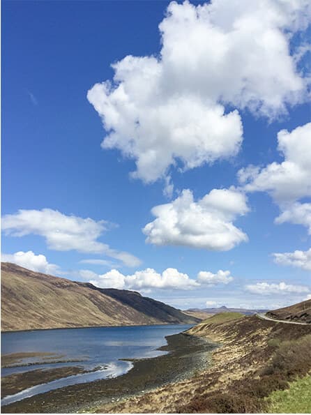 Loch and hills under blue Highland skies